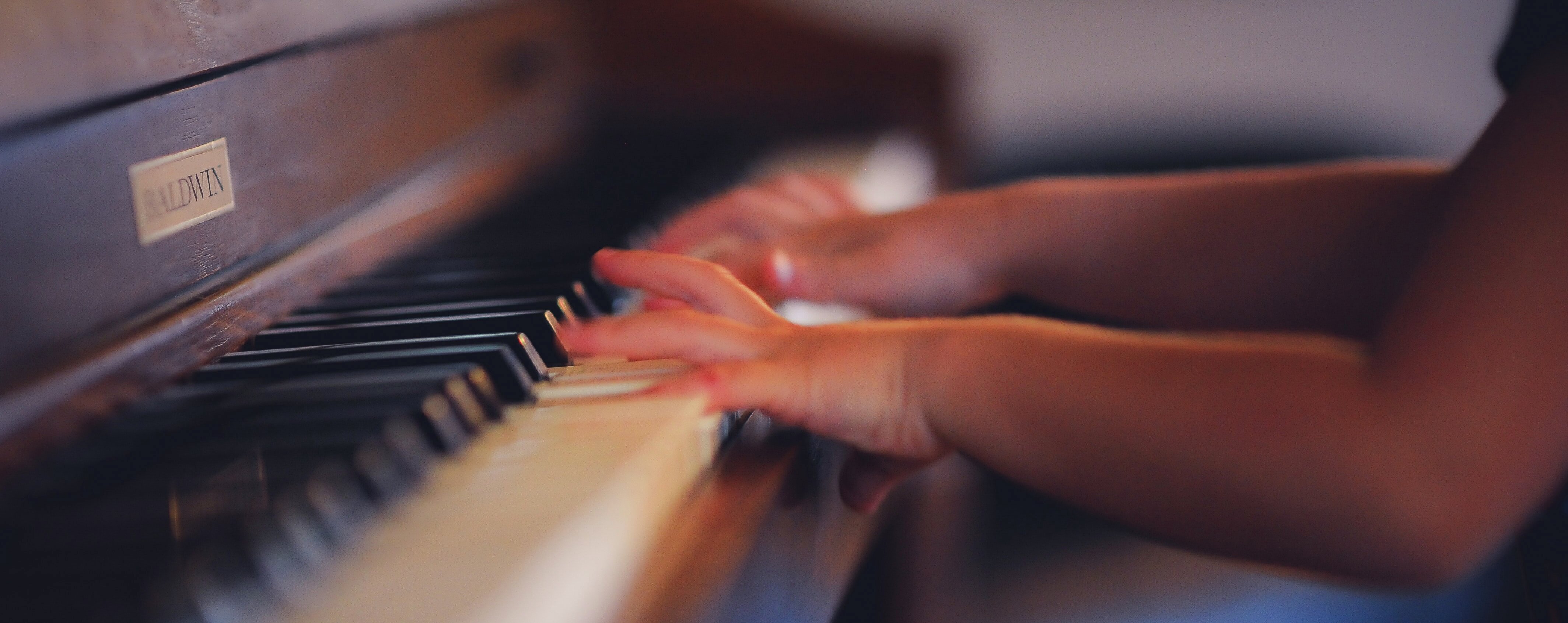 Barnehender spiller piano